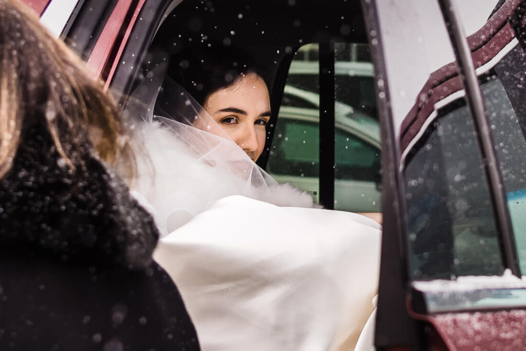 Bride in car before wedding ceremony at St. Agnes Church in Lake Placid, New York