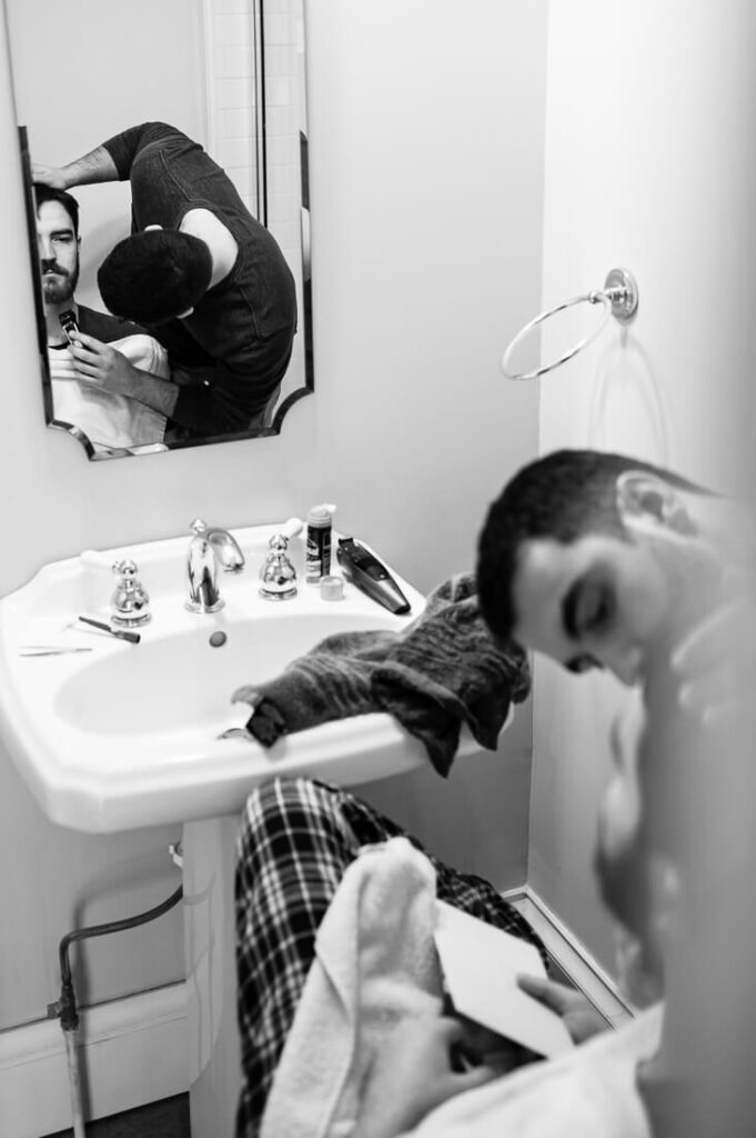 groom in the bathroom shaving before his wedding
