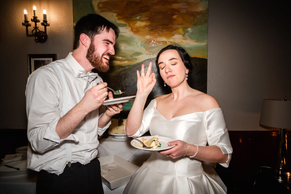 couple eating wedding cake at hotel saranac